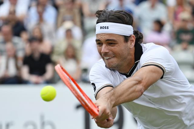 14 June 2026, Baden-Wuerttemberg, Stuttgart: American tennis player Taylor Fritz plays a backhand return against USA's Ben Shelton during their Men's Singles Final tennis match during Day Seven of the Stuttgart Open Tennis Tournament. Photo: Marijan Murat/dpa