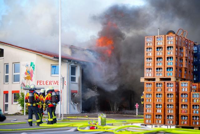 15 June 2026, Baden-Württemberg, Unterensingen: Firefighters stand in front of the burning fire station in Unterensingen. The fire in the Esslingen district caused approximately 10 million euros in damage. Four vehicles, a boat, and several pieces of equipment were destroyed, and the building caught significant damage, a police spokesperson said. Photo: -/SDMG/dpa