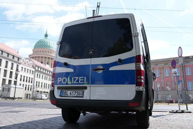 16 June 2026, Brandenburg, Potsdam: A police vehicle is parked in front of the state parliament (R). Parts of downtown Potsdam were evacuated due to the defusing of a 250-kilogram bomb from World War II. Photo: Sven Kaeuler/dpa