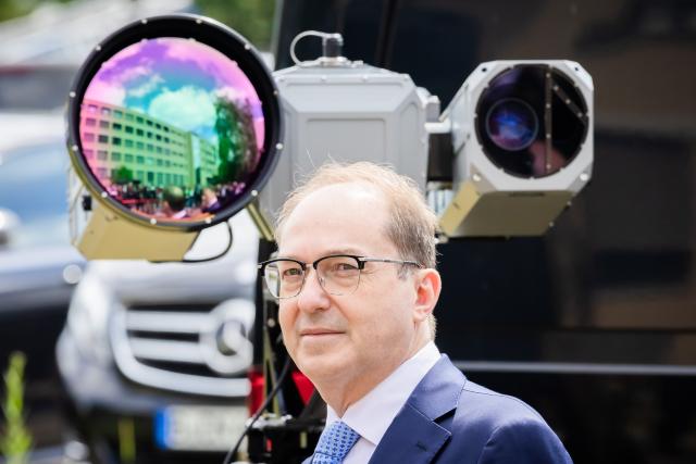 16 June 2026, Berlin: Alexander Dobrindt, German Minister of the Interior, stands in front of a Vision-Flex camera system designed to counter drones during the inauguration of the Joint Center for Countering Hybrid Threats (GAZ Hybrid). The new defense center will be located on the premises of the Federal Office for the Protection of the Constitution in Berlin-Treptow. Photo: Christoph Soeder/dpa