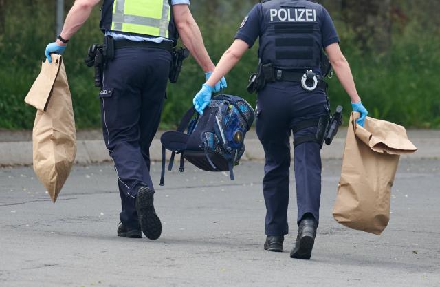 17 June 2026, North Rhine-Westphalia, Luedenscheid: Police officers work at the scene after a school bus hit a nine-year-old child. According to the initial investigation, the child reportedly ran out into the street suddenly and was struck by the bus. Photo: Bernd Thissen/dpa
