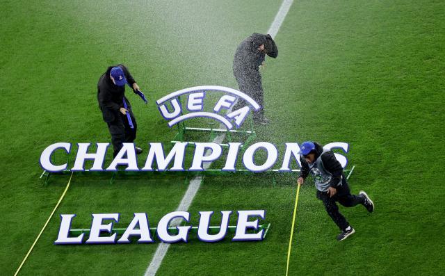 FILED - 11 March 2025, North Rhine-Westphalia, Leverkusen: Workers position the UEFA Champions League lettering on the pitch before the 2025 UEFA Champions League round of 16, second leg soccer match between Bayer 04 Leverkusen and FC Bayern Munich at the BayArena. Photo: Rolf Vennenbernd/dpa