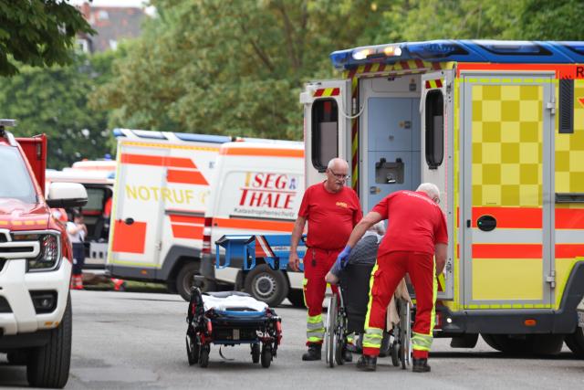 17 June 2026, Saxony-Anhalt, Blankenburg: Emergency responders are treating a patient next to an ambulance after a fire at the hospital in Blankenburg. Photo: Matthias Bein/dpa