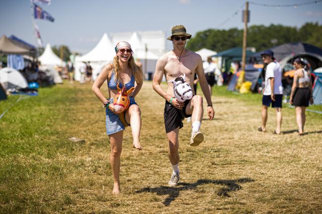 19 June 2026, Lower Saxony, Scheessel: Two festivalgoers, who go by the names Chrissi and Phiphszy at the festival, walk across the campground at the Hurricane Festival. The Hurricane open-air festival takes place from June 19 to 21. Photo: Moritz Frankenberg/dpa