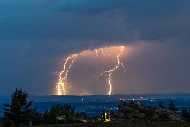 19 June 2026, Hesse, Schmitten: People watch lightning flashes during a thunderstorm at the Grosser Feldberg in the Taunus Mountains. Photo: Jan Eifert/dpa