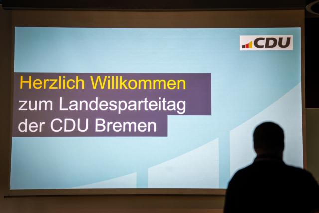 20 June 2026, Bremen: A man stands in front of a screen in the event hall bearing the inscription "A Warm Welcome to the Bremen CDU State Party Convention" ahead of the start of the Christian Democratic Union of Germany (CDU) state party convention in Bremen. Photo: Focke Strangmann/dpa