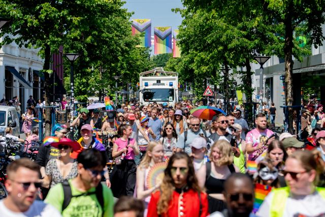 20 June 2026, Lower Saxony, Oldenburg: People march through downtown carrying flags and umbrellas during the Christopher Street Day (CSD) parade. Christopher Street Day is a demonstration and celebration of the LGBTQ+ rights. Photo: Hauke-Christian Dittrich/dpa