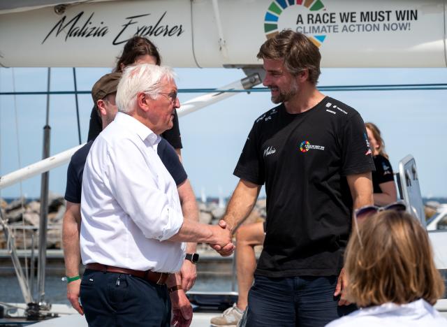 20 June 2026, Schleswig-Holstein, Kiel: German President Frank-Walter Steinmeier shakes hands with Boris Herrmann (R), a sailor,  on Herrmann's sailboat, the Malizia Explorer, and sail through the fjord as part of Kiel Week. Photo: Daniel Bockwoldt/dpa