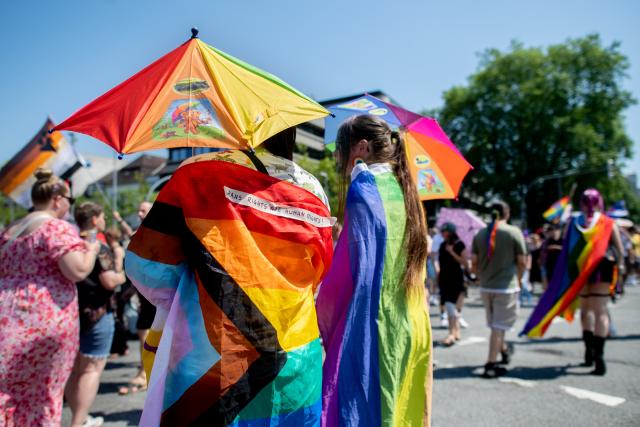 20 June 2026, Lower Saxony, Oldenburg: People march through downtown carrying flags and umbrellas during the Christopher Street Day (CSD) parade. Christopher Street Day is a demonstration and celebration of the LGBTQ+ rights. Photo: Hauke-Christian Dittrich/dpa