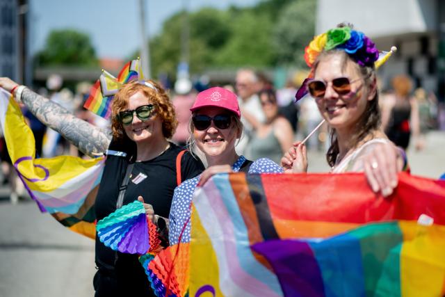 20 June 2026, Lower Saxony, Oldenburg: People march through downtown carrying flags and umbrellas during the Christopher Street Day (CSD) parade. Christopher Street Day is a demonstration and celebration of the LGBTQ+ rights. Photo: Hauke-Christian Dittrich/dpa