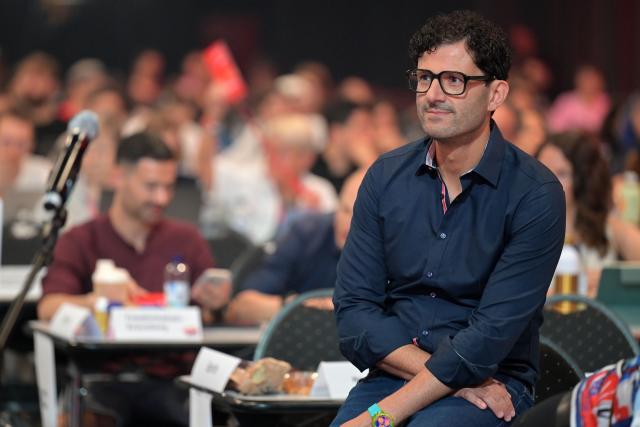 21 June 2026, Brandenburg, Potsdam: Luigi Pantisano, co-chair of The Left, is seated in the Metropolis Halle during the party's national convention. The three-day convention focuses on electing the party's executive committee and debating current political issues. Photo: Michael Bahlo/dpa
