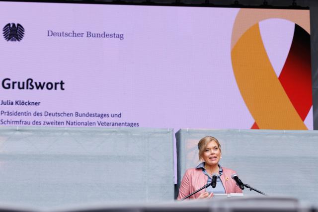 21 June 2026, Berlin: President of the German Bundestag, Julia Kloeckner speaks at the opening of a public festival held around the Reichstag building. On Veterans Day, Germany honors the service of Bundeswehr soldiers with a large-scale event taking place around the landmark building in Berlin. Photo: Carsten Koall/dpa