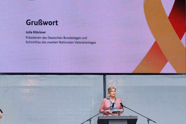 21 June 2026, Berlin: President of the German Bundestag, Julia Kloeckner speaks at the opening of a public festival held around the Reichstag building. On Veterans Day, Germany honors the service of Bundeswehr soldiers with a large-scale event taking place around the landmark building in Berlin. Photo: Carsten Koall/dpa