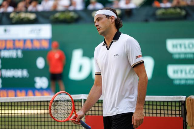 21 June 2026, North Rhine-Westphalia, Halle (Westfalen): US tennis player Taylor Fritz reacts during his men's singles final match against US Frances Tiafoe at the Halle Open tennis tournament. Photo: Friso Gentsch/dpa