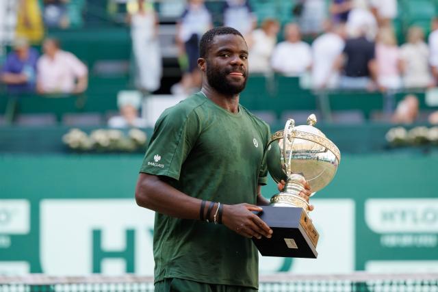 21 June 2026, North Rhine-Westphalia, Halle (Westfalen): US tennis player Frances Tiafoe holds the trophy after his victory over against US Taylor during the Halle Open tennis tournament. Photo: Friso Gentsch/dpa
