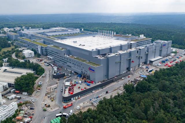22 June 2026, Saxony, Dresden: An aerial photo shows Infineon's new Smart Power Fab in Dresden. The semiconductor manufacturing plant is scheduled to officially begin operations on 02 July 2026, marking the early completion of the company's largest investment at the site. Production of chips on 300-millimetre wafers is set to start around three months ahead of schedule, and the facility is expected to create approximately 1,000 additional jobs. Photo: Robert Michael/dpa