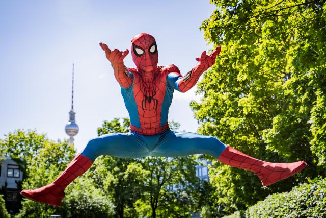 22 June 2026, Berlin: A spider man actor jumps in Jacob-Teitel Park in front of the Berlin TV Tower ahead of a fan event for Spider-Man: Brand New Day Photo: Christoph Soeder/dpa