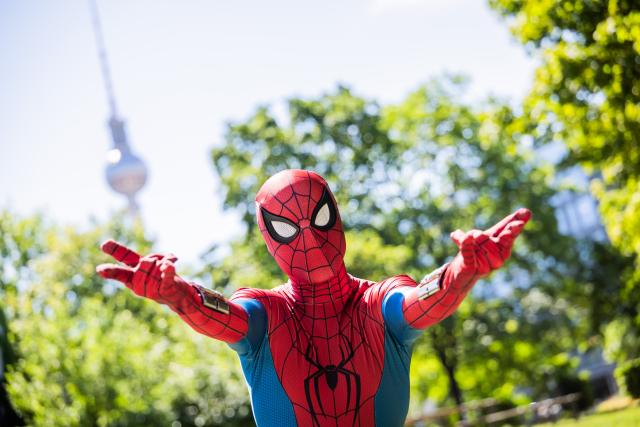 22 June 2026, Berlin: A spider man actor gestures in Jacob-Teitel Park in front of the Berlin TV Tower ahead of a fan event for Spider-Man: Brand New Day. Photo: Christoph Soeder/dpa