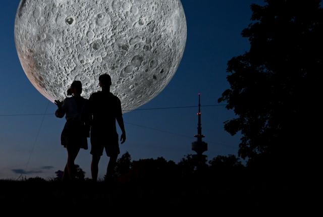 22 June 2026, Bavaria, Munich: The installation "Museum of the Moon" by British artist Luke Jerram is on display at the Tollwood Festival. Photo: Sven Hoppe/dpa