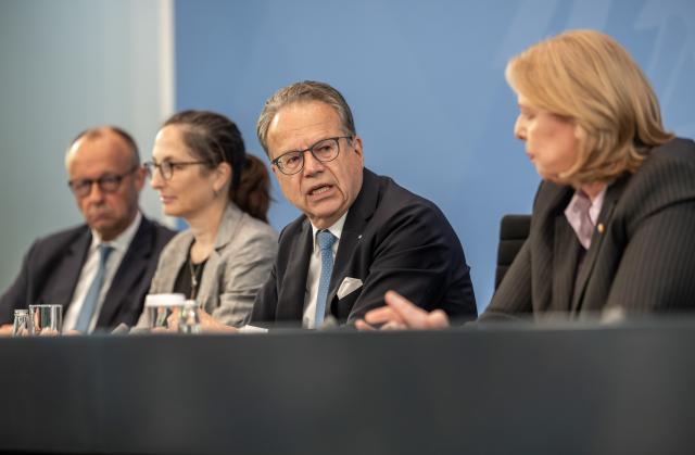 23 June 2026, Berlin: (L-R) Friedrich Merz, German Chancellor, Constanze Janda, Co-chair of the Pension Commission, Frank-Juergen Weise, Co-chair of the Pension Commission, and Baerbel Bas, German Minister of Labour and Social Affairs and Chair of the Social Democratic Party, attend a press conference following the presentation of the Pension Security Commission's report on pension reform. Photo: Michael Kappeler/dpa