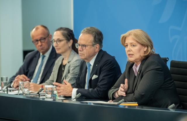23 June 2026, Berlin: (L-R) Friedrich Merz, German Chancellor, Constanze Janda, Co-chair of the Pension Commission, Frank-Juergen Weise, Co-chair of the Pension Commission, and Baerbel Bas, German Minister of Labour and Social Affairs and Chair of the Social Democratic Party, attend a press conference following the presentation of the Pension Security Commission's report on pension reform. Photo: Michael Kappeler/dpa