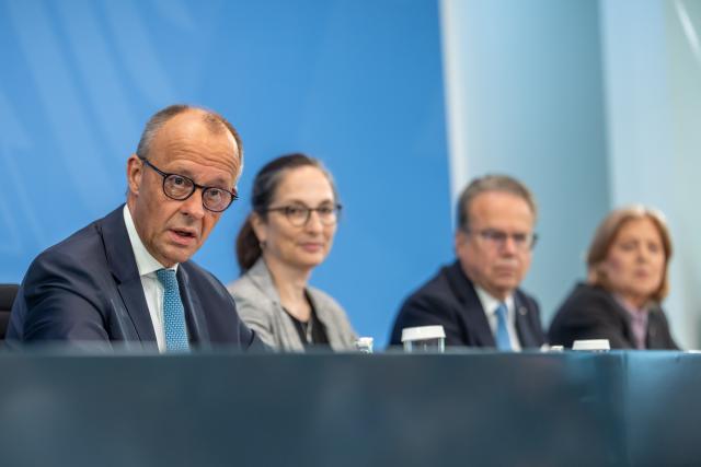 23 June 2026, Berlin: (L-R) Friedrich Merz, German Chancellor, Constanze Janda, Co-chair of the Pension Commission, Frank-Juergen Weise, Co-chair of the Pension Commission, and Baerbel Bas, German Minister of Labour and Social Affairs and Chair of the Social Democratic Party, attend a press conference following the presentation of the Pension Security Commission's report on pension reform. Photo: Michael Kappeler/dpa
