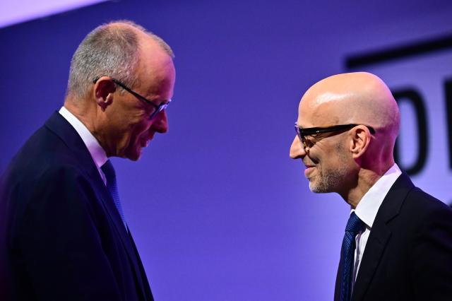 23 June 2026, Berlin: German Chancellor Friedrich Merz speaks Peter Leibinger, president of the Federation of German Industries (BDI), during the 2026 Industry Day event organized by the Federation of German Industries. Photo: Sebastian Gollnow/dpa