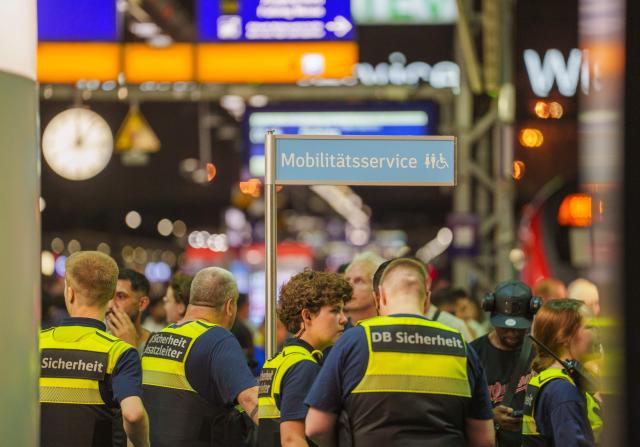 23 June 2026, Frankfurt_Main: Security personnel are on high alert at the service counter at the main train station in Frankfurt am Main. Germany's Deutsche Bahn temporarily suspended its train services nationwide on Tuesday evening following a disruption to its communications system, the state-owned rail operator said.. Photo: Andreas Arnold/dpa
