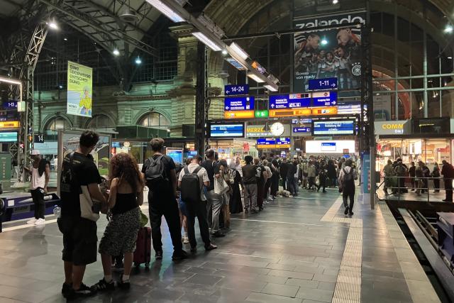 23 June 2026, Frankfurt: Travelers are waiting in line in front of the information desk at Frankfurt Central Station. Germany's Deutsche Bahn temporarily suspended its train services nationwide on Tuesday evening following a disruption to its communications system, the state-owned rail operator said.. Photo: ---/dpa