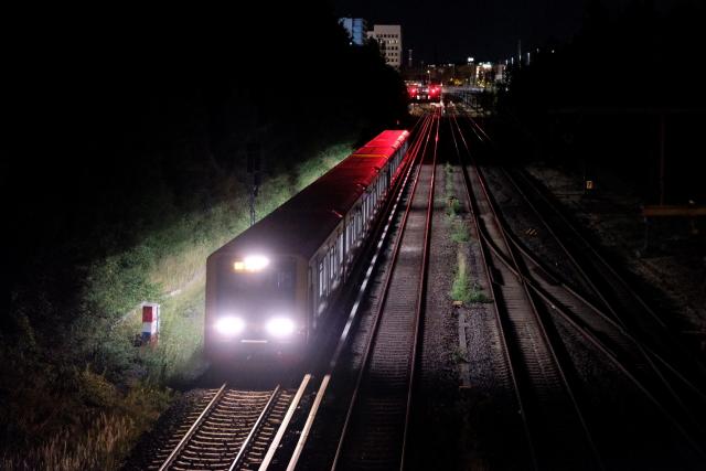 23 June 2026, Berlin: A Berlin S-Bahn train traveling on the Ringbahn over the Kniprodestraße Bridge.  Germany's Deutsche Bahn temporarily suspended its train services nationwide on Tuesday evening following a disruption to its communications system, the state-owned rail operator said.. Photo: Niklas Graeber/dpa