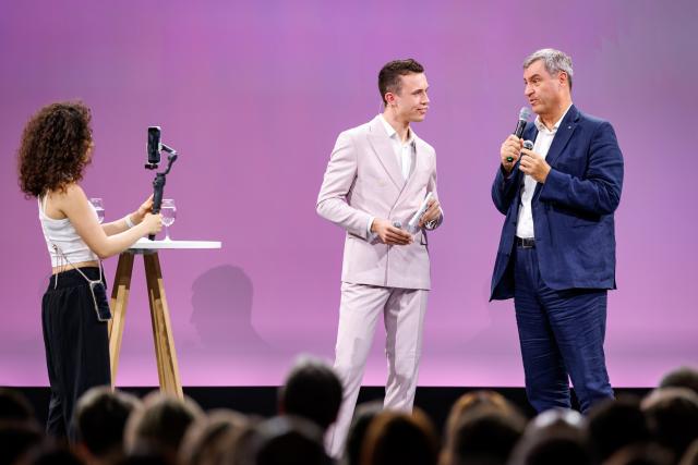 24 June 2026, Bavaria, Nuremberg: Markus Soeder (R), Minister-President of Bavaria, speaks alongside host Elian Preuhs during the opening of the Local Media Days at the Nuremberg Exhibition Centre. Photo: Daniel Karmann/dpa