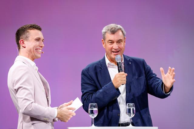24 June 2026, Bavaria, Nuremberg: Markus Soeder (R), Minister-President of Bavaria, speaks alongside host Elian Preuhs during the opening of the Local Media Days at the Nuremberg Exhibition Centre. Photo: Daniel Karmann/dpa