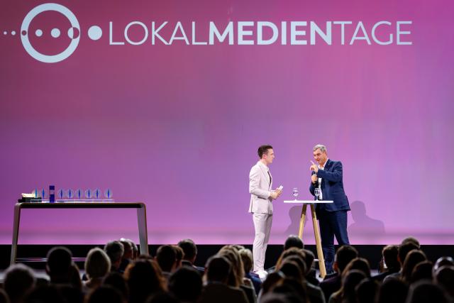 24 June 2026, Bavaria, Nuremberg: Markus Soeder (R), Minister-President of Bavaria, speaks alongside host Elian Preuhs during the opening of the Local Media Days at the Nuremberg Exhibition Centre. Photo: Daniel Karmann/dpa