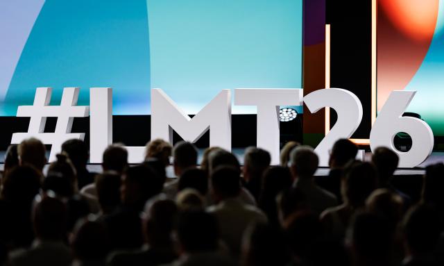 24 June 2026, Bavaria, Nuremberg: The hashtag for the 2026 Local Media Days, "#LMT26," is displayed in oversized letters on the stage at the Nuremberg Exhibition Center. Photo: Daniel Karmann/dpa
