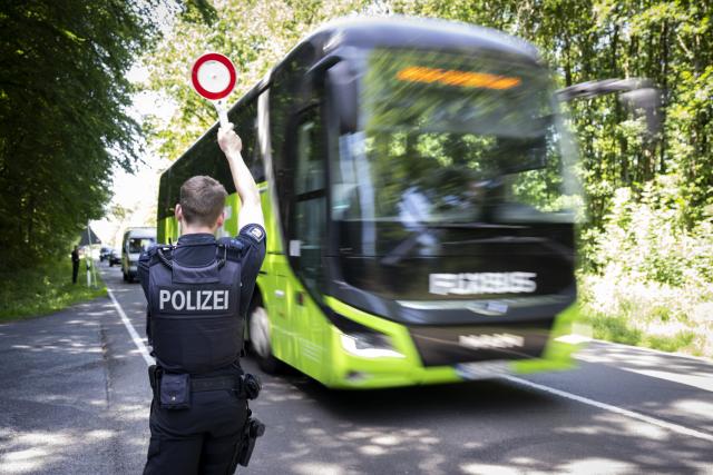 24 June 2026, Mecklenburg-Western Pomerania, Larz: A police officer uses a paddle to signal vehicles to pull over during a traffic stop. To mark the start of the 27th Fusion Festival, the police had announced a large-scale operation around the festival grounds. Customs officials are also on site. Photo: Philip Dulian/dpa