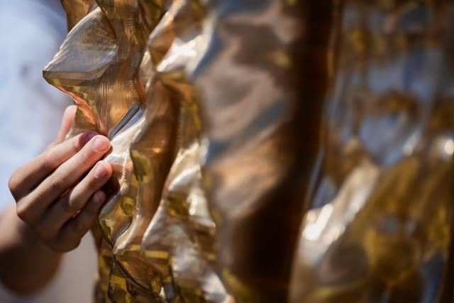 24 June 2026, Berlin: A person touches the memorial to the Jehovah's Witnesses persecuted and murdered under the Nazi regime, located in Berlin's Tiergarten park. Photo: Christoph Soeder/dpa