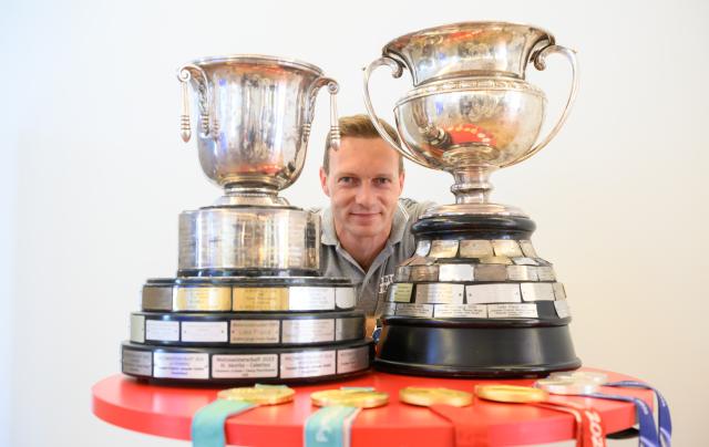 25 June 2026, Saxony, Dresden: German bobsledder Francesco Friedrich stands at a table with his World Championship trophies and Olympic medals before a press conference. The world's most successful bobsled pilot will continue his bobsledding career through the 2030 Winter Olympics. Photo: Robert Michael/dpa