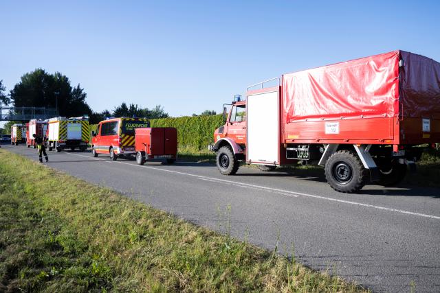 25 June 2026, Mecklenburg-Western Pomerania, Laerz: Fire trucks are parked on the Fusion Festival grounds. The Festival has been interrupted due to a fire outside the grounds. Photo: Philip Dulian/dpa