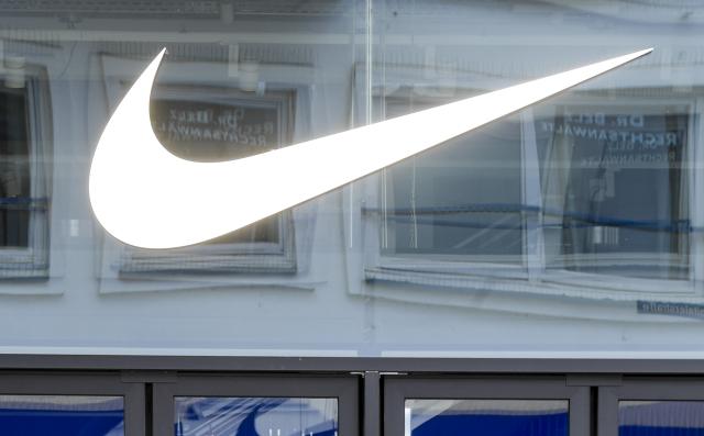 FILED - 01 April 2020, Hamburg: FILE PHOTO - The American athletic footwear Nike's logo is seen above the entrance to the department store in down town Hamburg. Photo: Axel Heimken/dpa