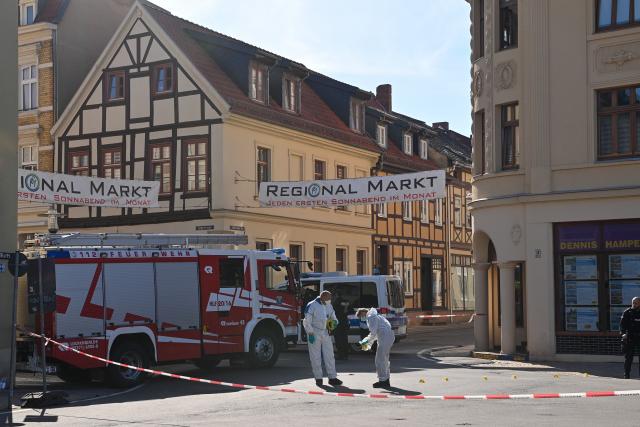 26 June 2026, Saxony-Anhalt, Haldensleben: Forensic investigators examine a crime scene on the edge of the market square as police conduct an operation following an incident in which at least one person was injured, according to the Magdeburg Police Department. Photo: Klaus-Dietmar Gabbert/dpa