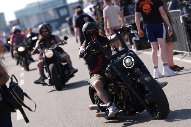 26 June 2026, Hamburg: Motorcycles ride through the event grounds at the Hamburg Wholesale Market during the opening day of Harley Days, Europe's largest inner-city biker gathering. Photo: Marcus Brandt/dpa