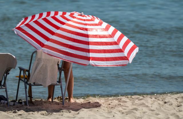 27 June 2026, Mecklenburg-Western Pomerania, Binz: A visitor enjoys the beach at a seaside resort on the island of Ruegen, during a summer heatwave. Photo: Stefan Sauer/dpa