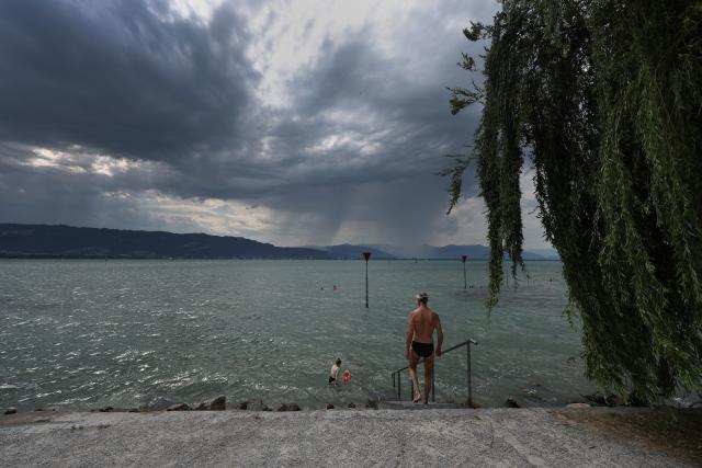 28 June 2026, Bavaria, Lindau am Bodensee: As clouds roll in, day-trippers seek relief from the heat in Lake Constance. Photo: Karl-Josef Hildenbrand/dpa