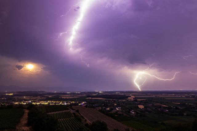 28 June 2026, Baden-Wuerttemberg, Ihringen: Lightning strikes over the Rhine Valley, with the Kaiserstuhl visible in the foreground. Photo: Philipp von Ditfurth/dpa