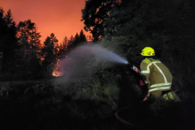 HANDOUT - 29 June 2026, Bavaria, Übersee: Firefighters are battling a forest fire in the area of the municipality of Übersee am Chiemsee. As a result, the nearby A8 is completely closed. Photo: Wolfgang Gasser/Kreisfeuerwehrverband Traunstein/dpa - ATTENTION: For editorial use only in connection with current news coverage, and only with full attribution as stated above