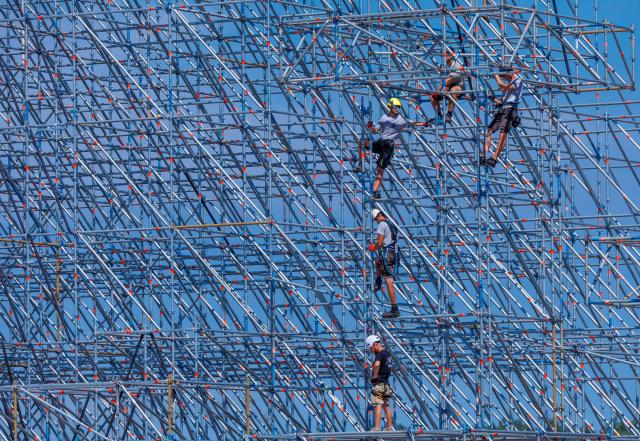 30 June 2026, Mecklenburg-Western Pomerania, Neustadt-Glewe: Scaffolders are assembling one of the main stages on the grounds of the "Airbeat One" festival at the airport. Northern Germany's largest electronic music festival will take place from July 9-12, 2026; over 300 DJs and more than 200,000 visitors from around the world are expected to attend. Photo: Jens Büttner/dpa