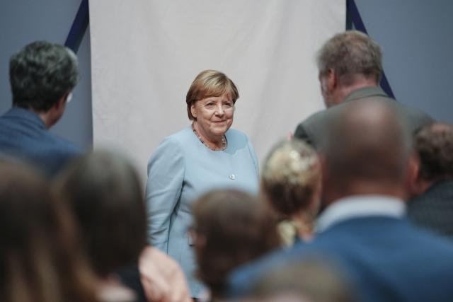 30 June 2026, Berlin: Former German chancellor Angela Merkel (C) attends the unveiling of her portrait for the Hall of Ancestors at the Federal Chancellery. The portrait will be on display at the Bode Museum until October 4, 2026, before being moved to the Federal Chancellery. Photo: Kay Nietfeld/dpa