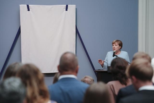30 June 2026, Berlin: Former German chancellor Angela Merkel speaks during the unveiling of her portrait for the Hall of Ancestors at the Federal Chancellery. The portrait will be on display at the Bode Museum until October 4, 2026, before being moved to the Federal Chancellery. Photo: Kay Nietfeld/dpa