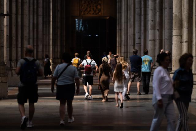 01 July 2026, North Rhine-Westphalia, Cologne: Tourists walk through Cologne Cathedral. From 1 July, admission to the cathedral costs visitors 12 euros. Those wishing to pray continue to have free access to a designated area. Photo: Rolf Vennenbernd/dpa