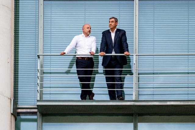 01 July 2026, Berlin: Alexander Hoffmann (L), deputy chairman of the Christian Democratic Union of Germany and Christian Social Union in Bavaria parliamentary group in the Bundestag, and Markus Soeder, Minister-President of Bavaria, stand on a balcony at the German Chancellery during the coalition committee meeting. Coalition leaders seek to agree on key points for a package of reforms. Photo: Fabian Sommer/dpa
